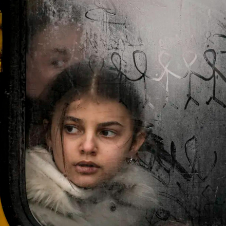 A child looks out a steamed-up bus window as civilians are evacuated from Irpin, on the outskirts of Kyiv