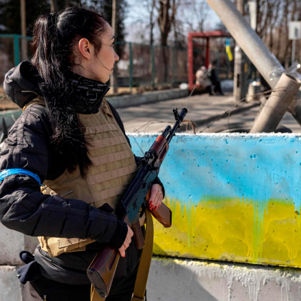A volunteer takes position at a checkpoint in a district in Kyiv