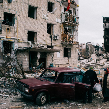 An elderly couple collects belongings from their bombed apartment in Borodyanka