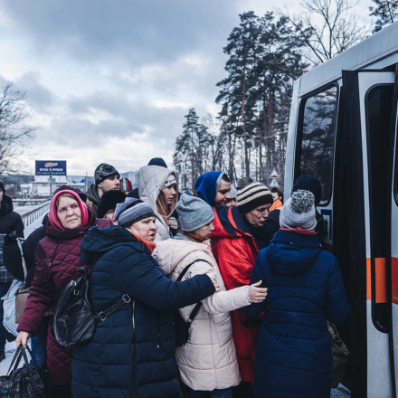 People board an evacuation bus as civilians continue to flee Russian attacks in Irpin