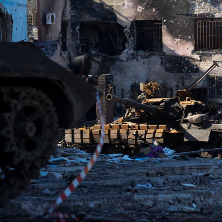 A damaged tank sits in a debris-strewn street in the city of Mariupol