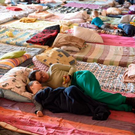 People rest in a special room for refugees at a railway station in Lviv